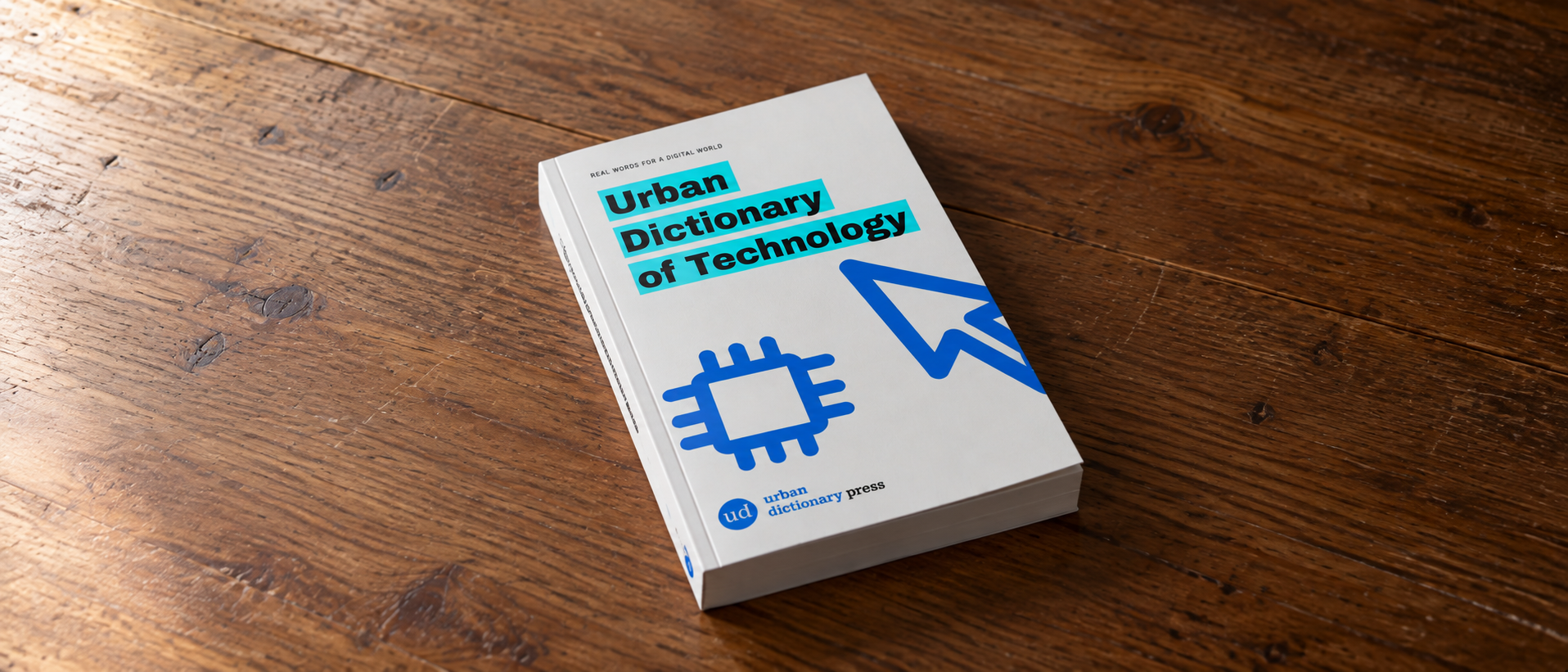 Urban Dictionary of Technology paperback on a wooden table